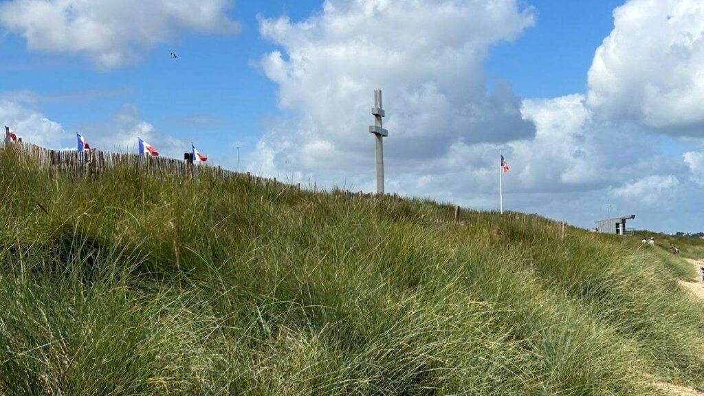Juno Beach in Normandy, a historic D-Day landing site where Canadian forces came ashore, now a peaceful shoreline visited by travelers honoring World War II history.