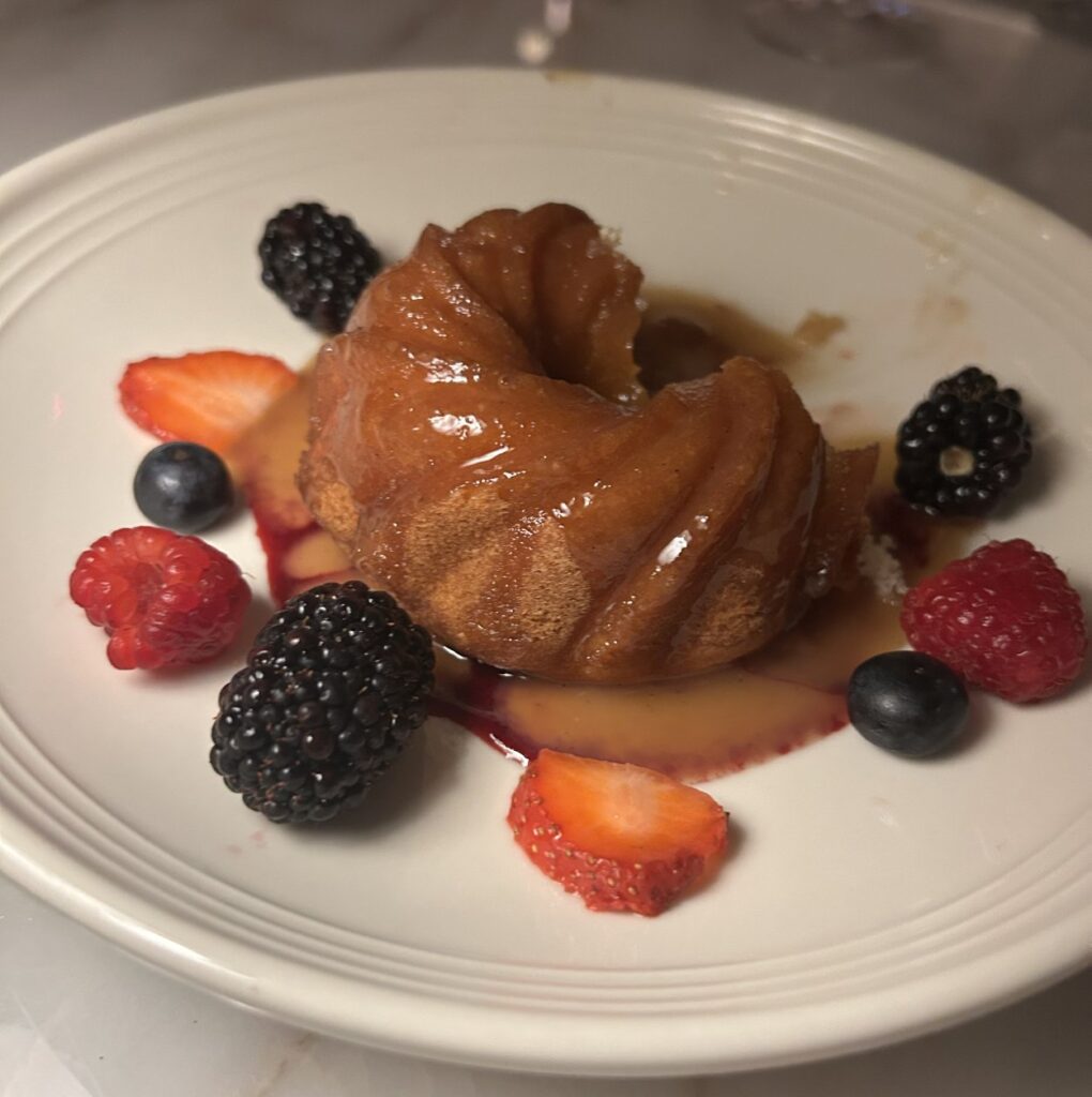 Buttercake with berry compote and caramel sauce is a decadent dessert served at 1587 Prime.