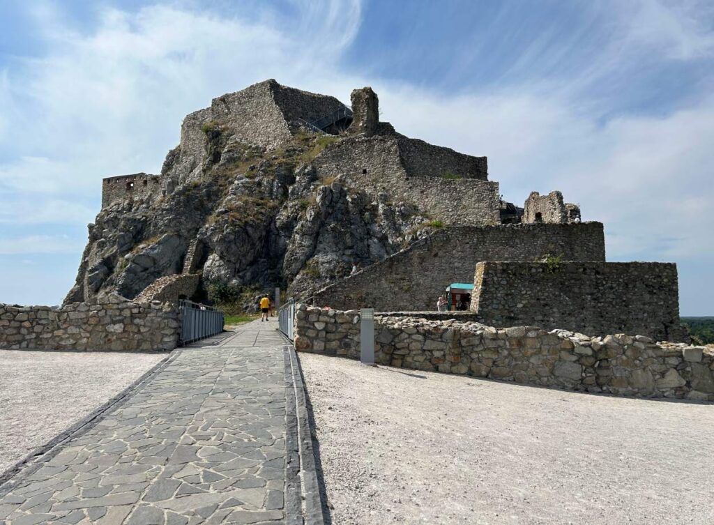 Stone ruins of Devín Castle perched on a rocky cliff above the river is a must visit on a 1 day trip to Bratislava