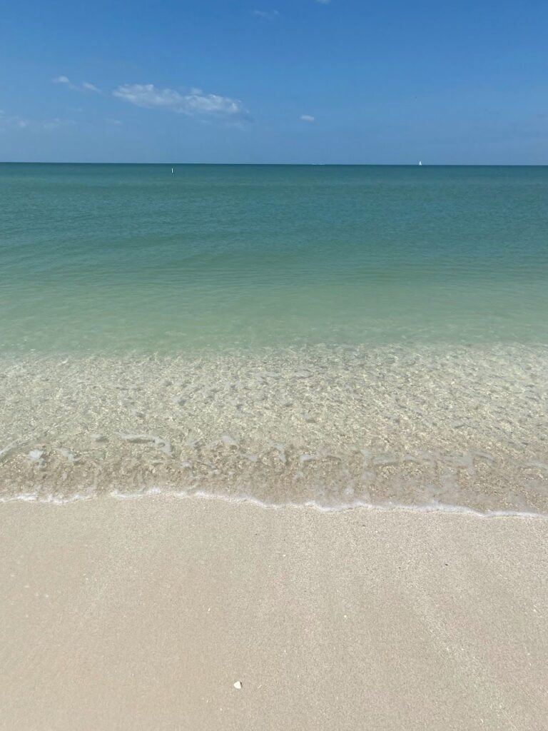 Peaceful beach scene in Bonita Springs with soft white sand and gentle waves