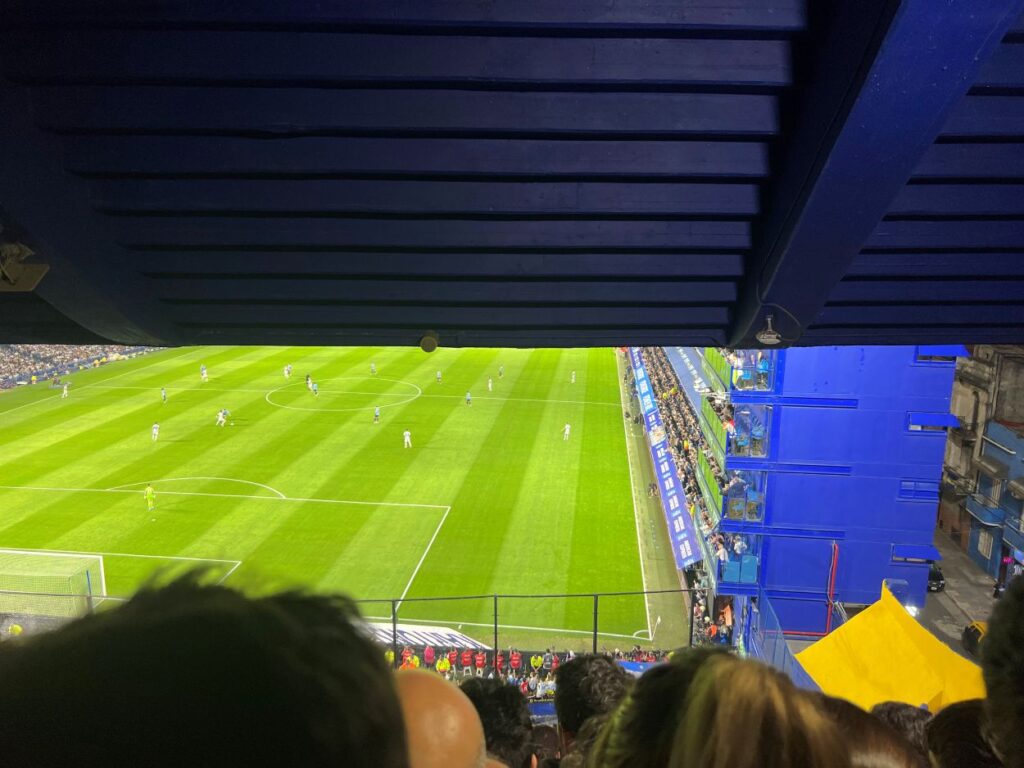 Passionate football fans celebrating during Argentina vs Uruguay game in Buenos Aires