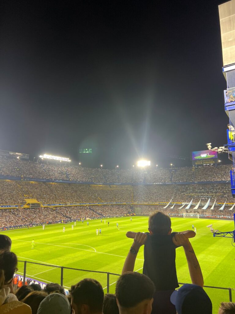 Fans cheering during an Argentina vs Uruguay football match in Buenos Aires stadium