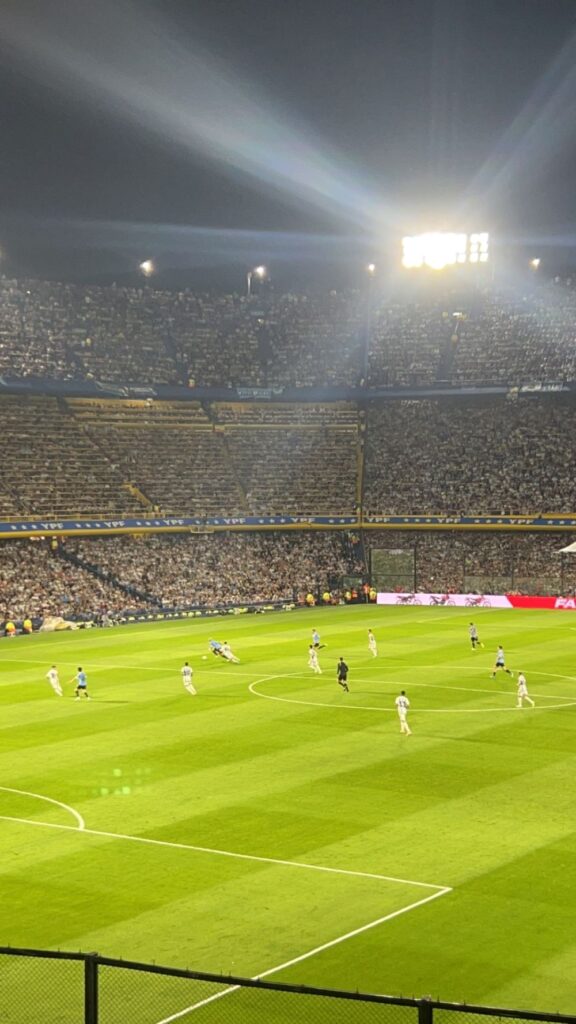 Watching Lionel Messi playing a live football match in Argentina.