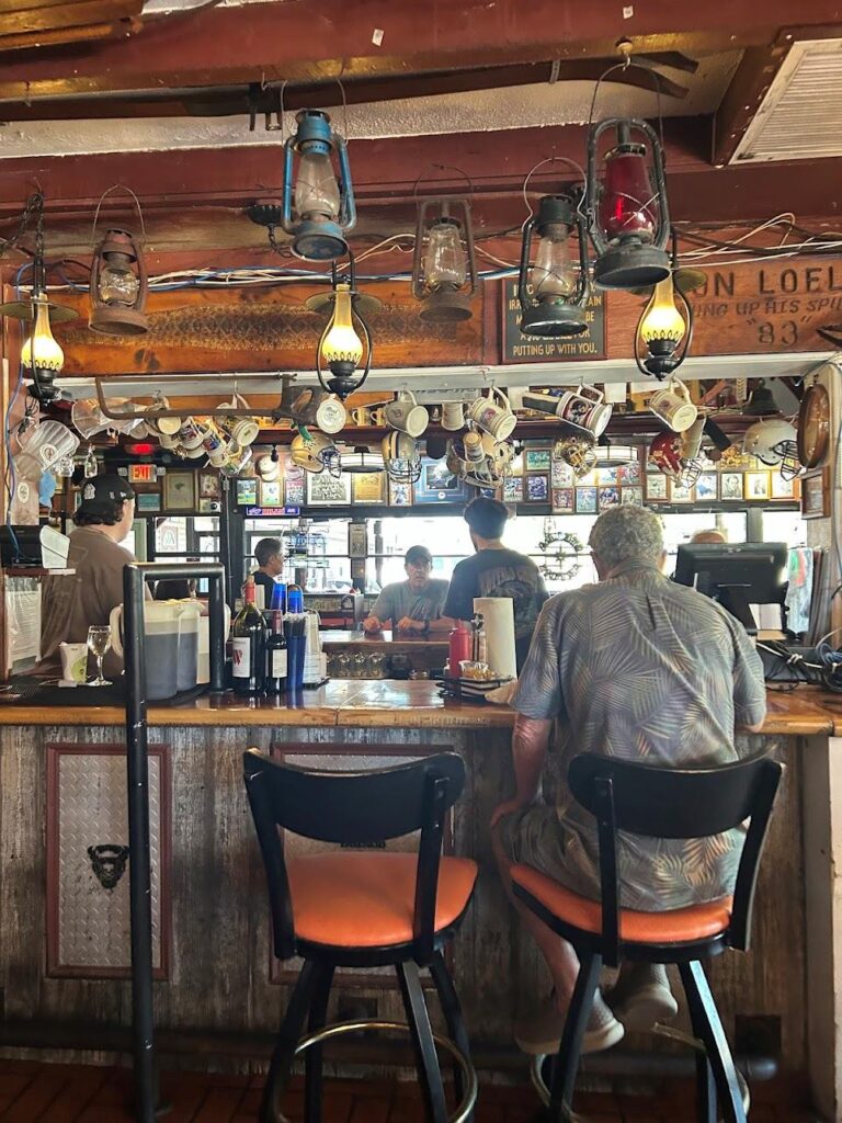 Lively dining space inside Buffalo Chips Restaurant with walls lined with Bills, Sabres, and Packers memorabilia