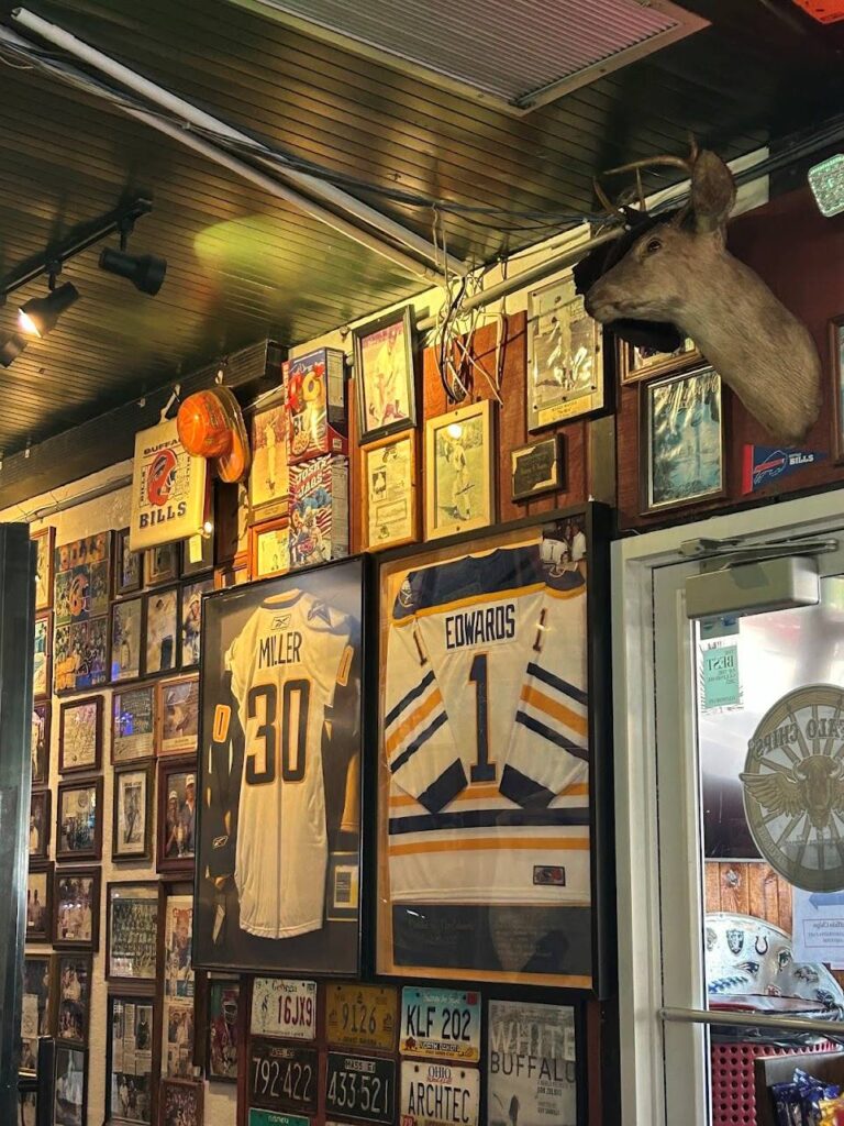 Interior of Buffalo Chips Restaurant resembling a Buffalo sports museum with walls covered in Bills and Sabres memorabilia