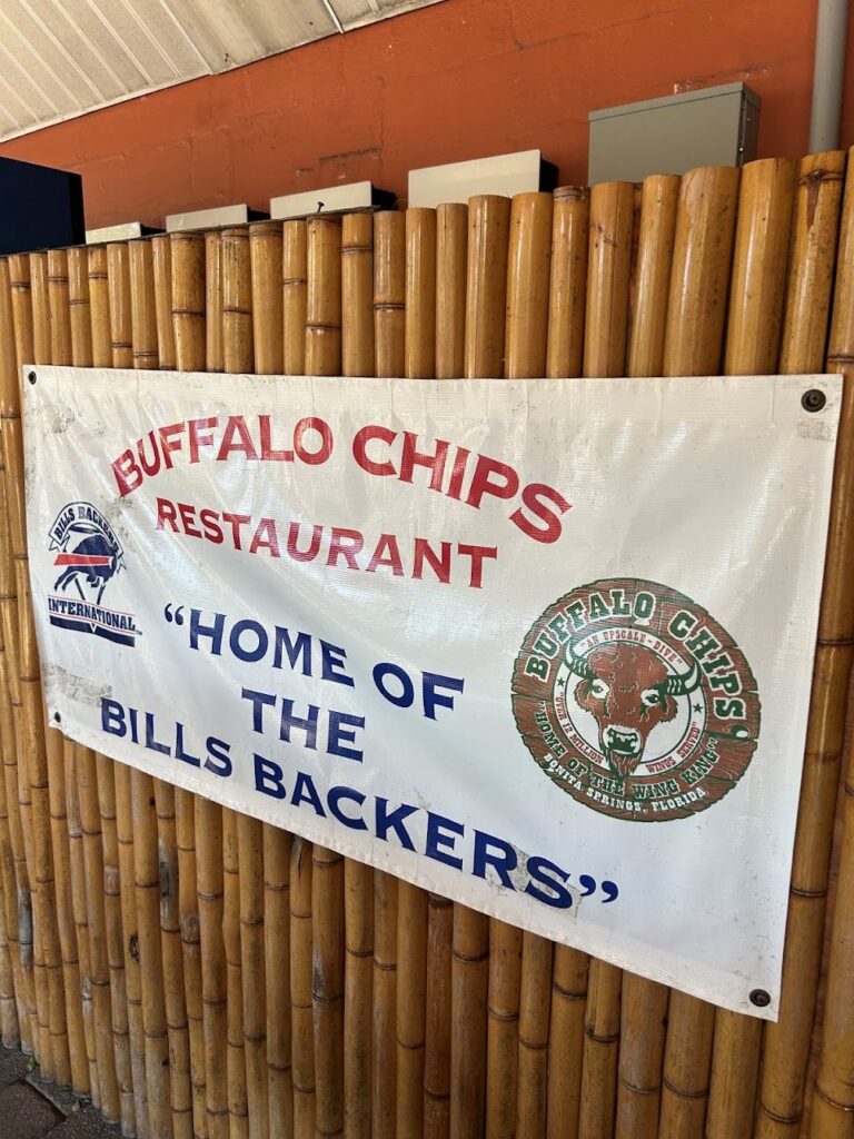A display board with the words "Home of the Bills Backers" placed inside Buffalo Chips Restaurant