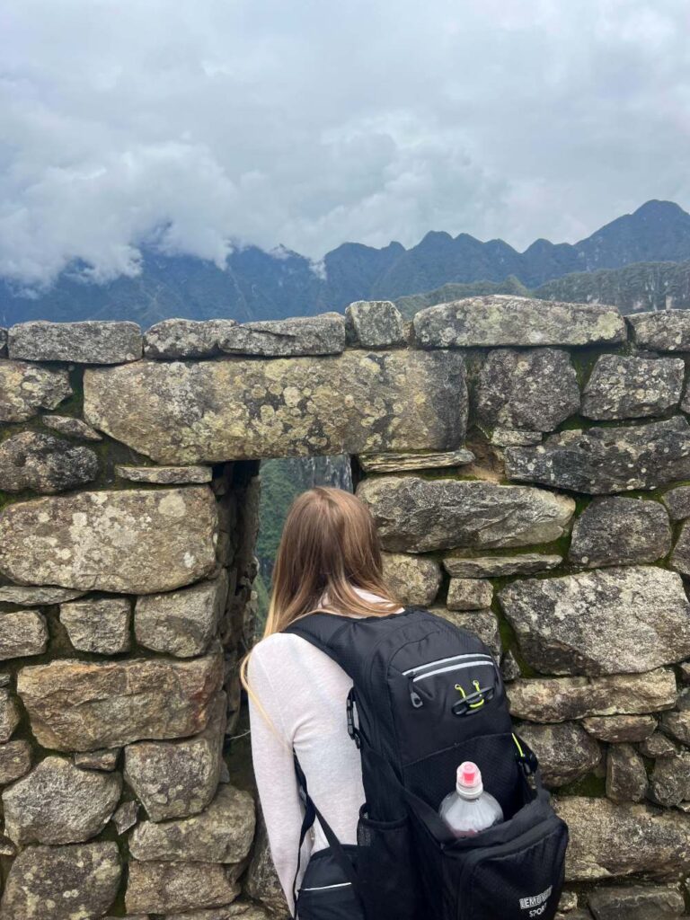 Walking through ancient stone terraces at Machu Picchu during a day trip