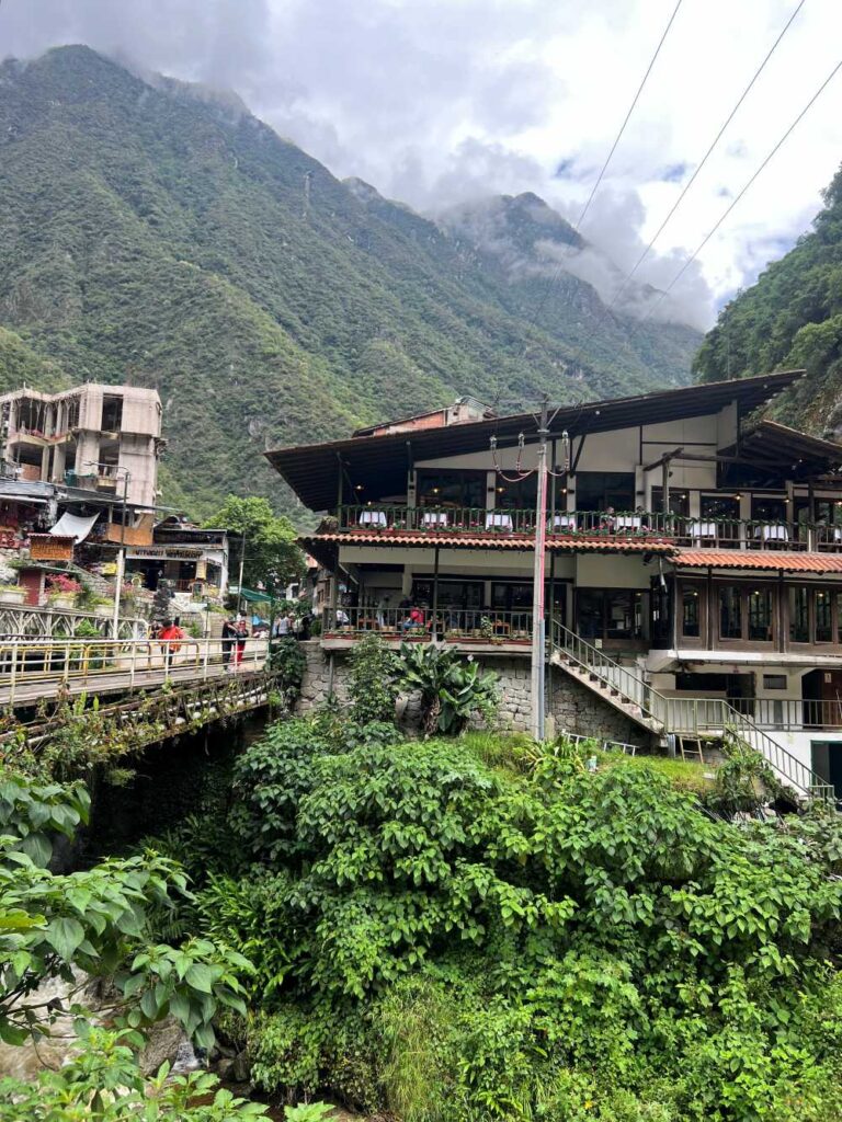 Bustling streets of Aguas Calientes filled with shops, cafés, and traveler