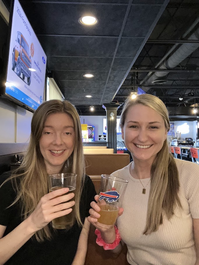 Two travelers reviewing the best Buffalo wings in Southwest Florida. 