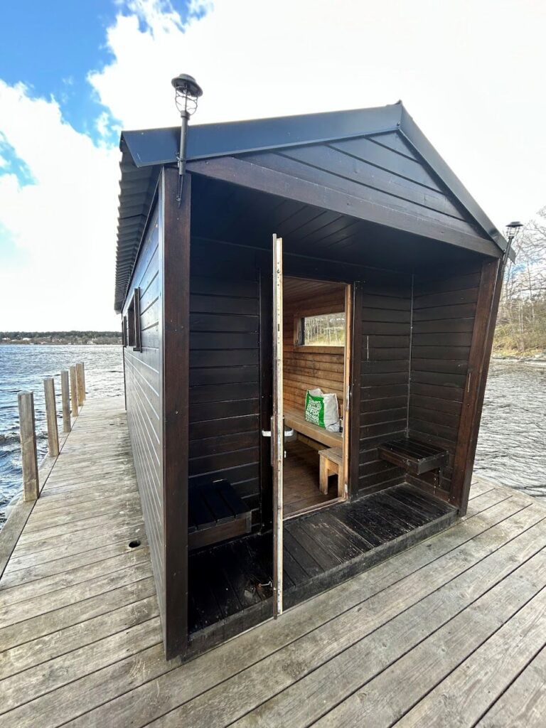 Traditional Scandinavian floating sauna surrounded by icy Baltic waters near Stockholm.