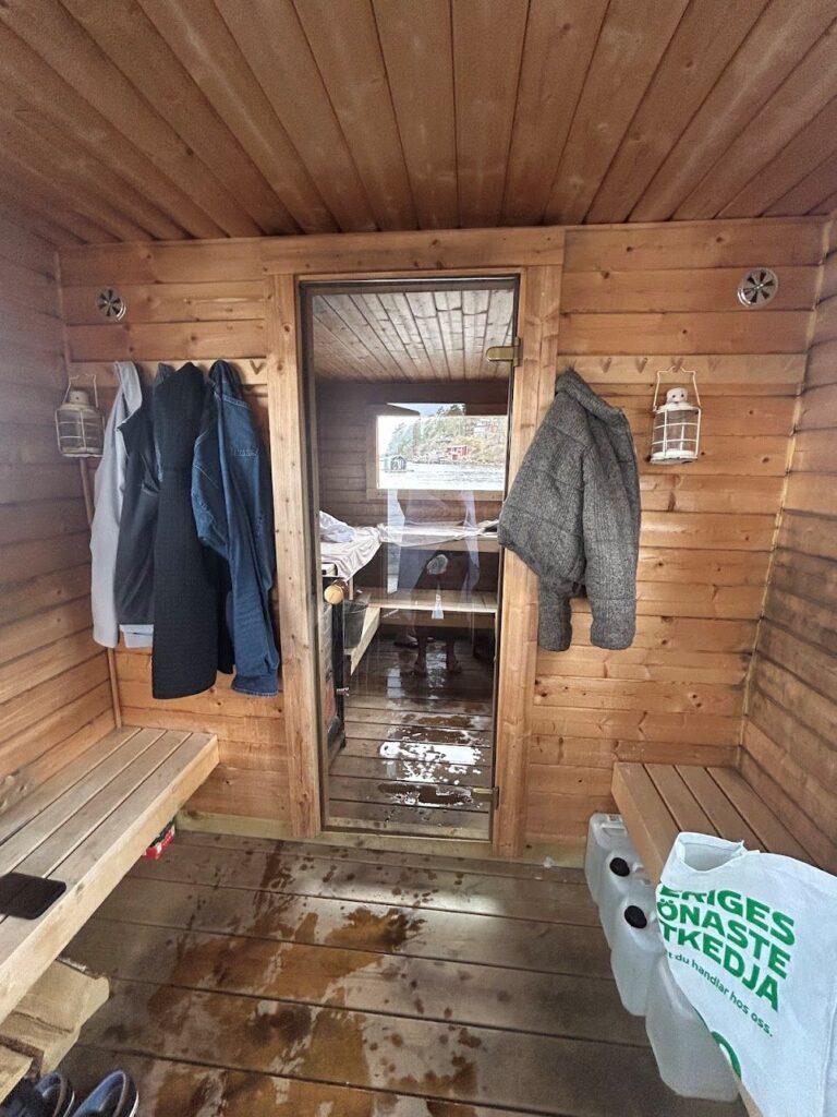 Inside the wood-fired floating sauna experience in the scenic Stockholm Archipelago.