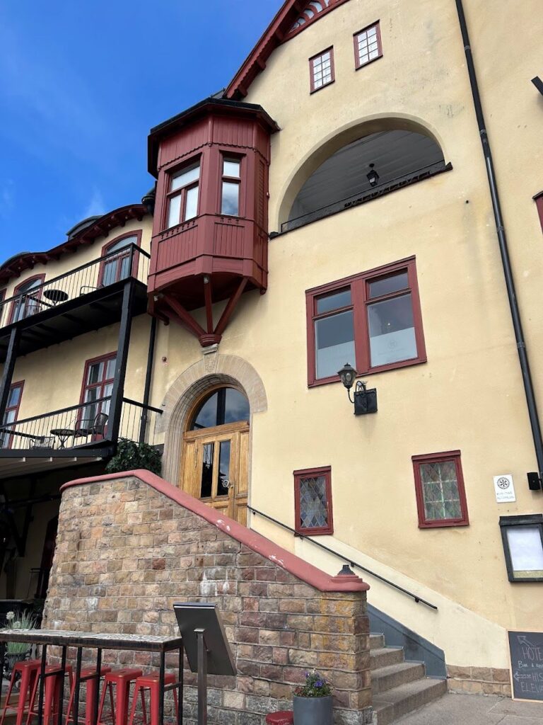 Charming exterior of Waxholms Hotell overlooking the harbor, a must-visit on a Vaxholm day trip