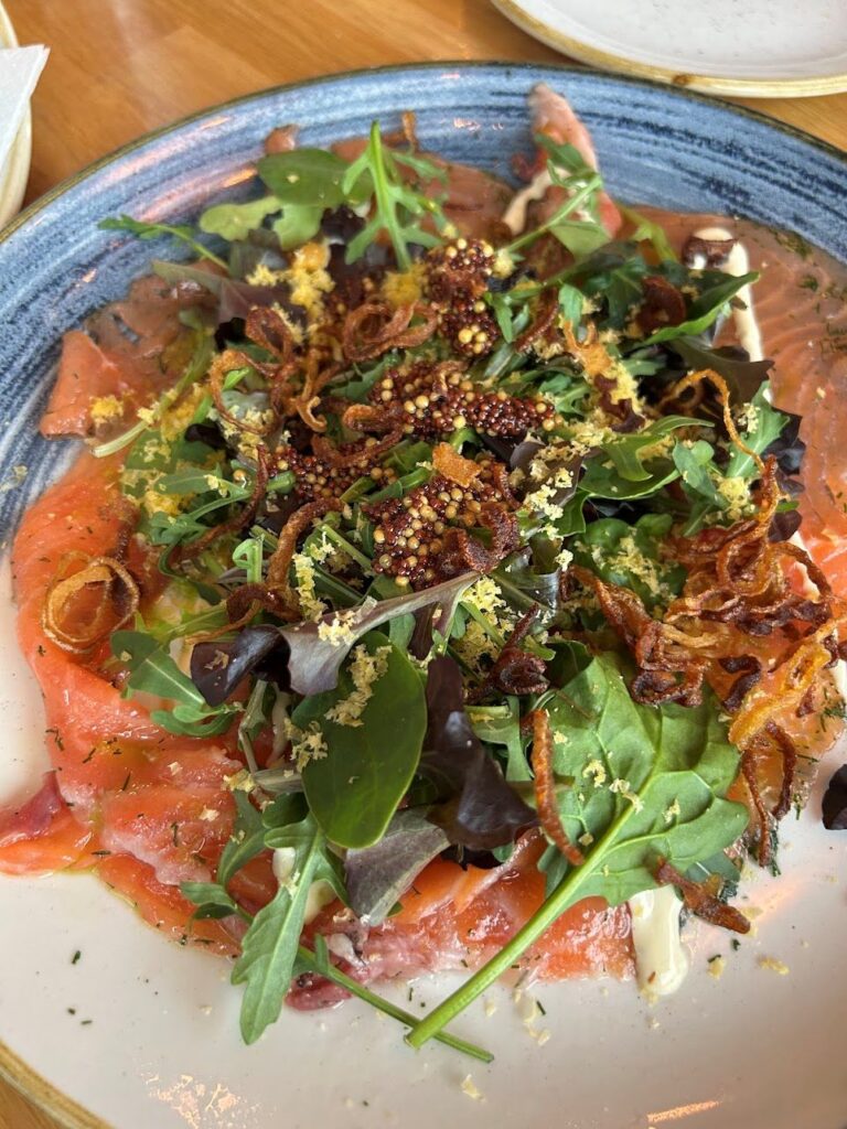 Cured salmon carpaccio served at Hamnkrogen Vaxholm with elegant waterfront dining ambiance