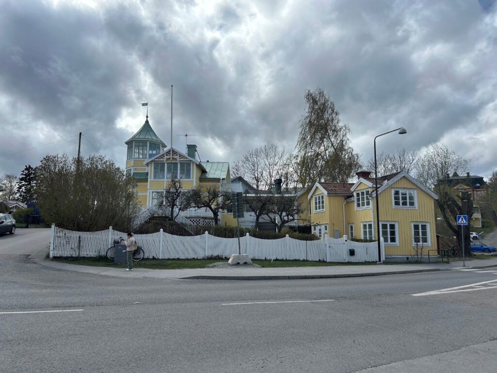 A warm yellow wooden mansion located in the harbor town of Vaxholm.