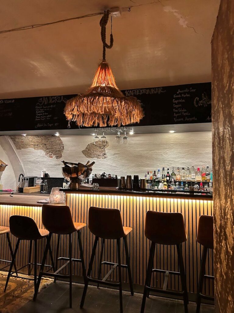 The warm-lit interiors of the underground restaurant, Vinvalvet 1644, Stockholm.