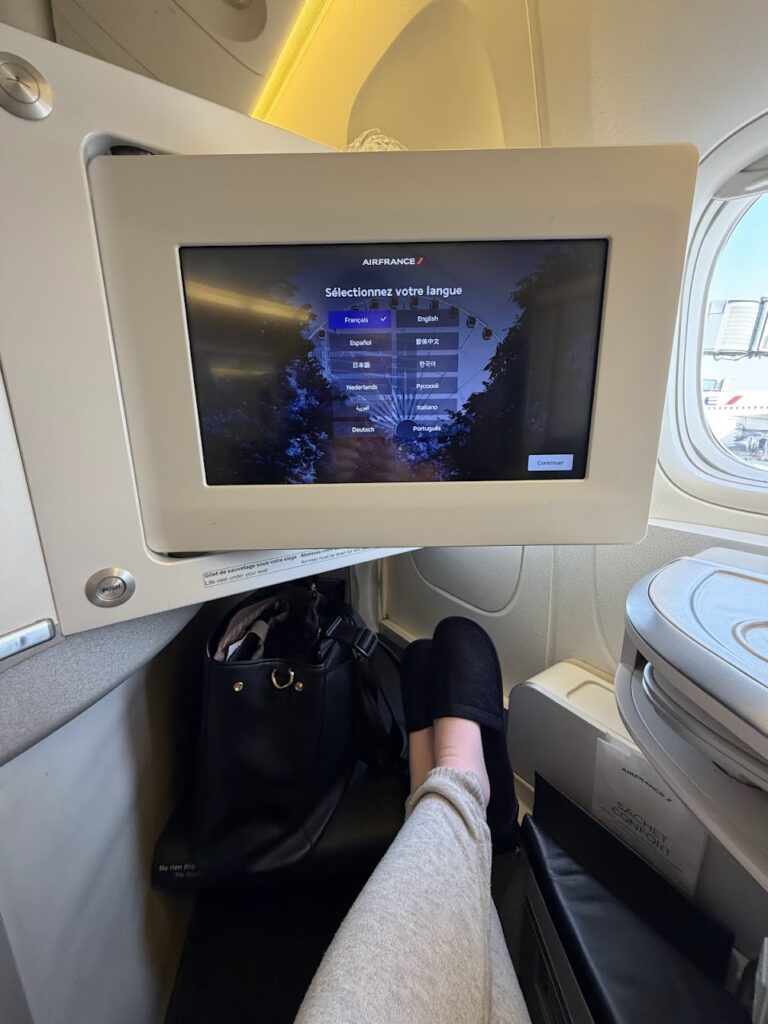 The seating in the Air France business class comes with storage space, HD TV, and comfortable slippers for a relaxed journey.