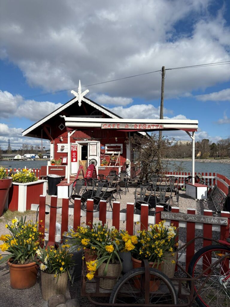 Charming red wooden cabin of Café Regatta beside the waterfront in Helsinki, a popular cafe