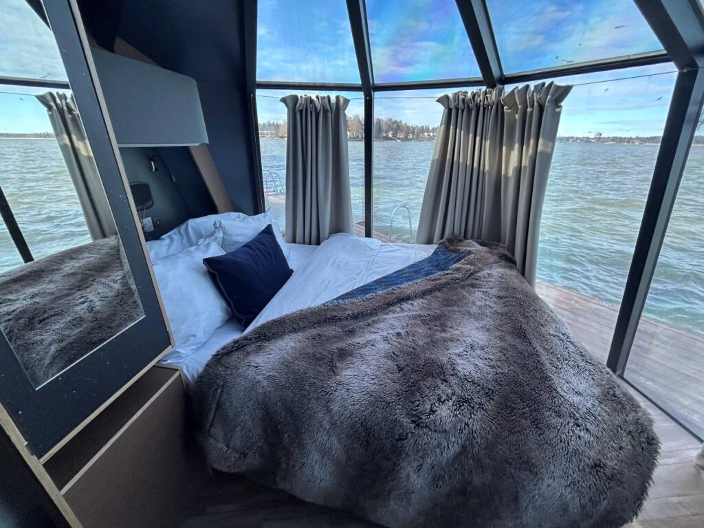 Spacious guest room at Hilton Helsinki Kalastajatorppa with large windows and sea views