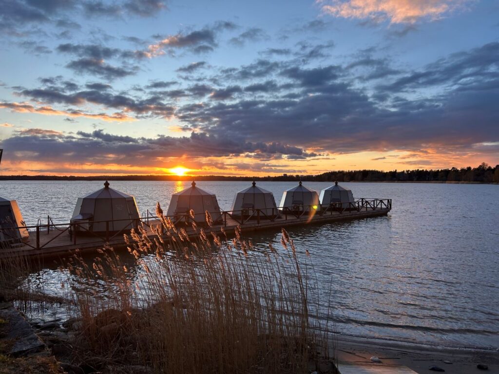Sunset over the shoreline at Hilton Helsinki Kalastajatorppa showcasing its seaside location