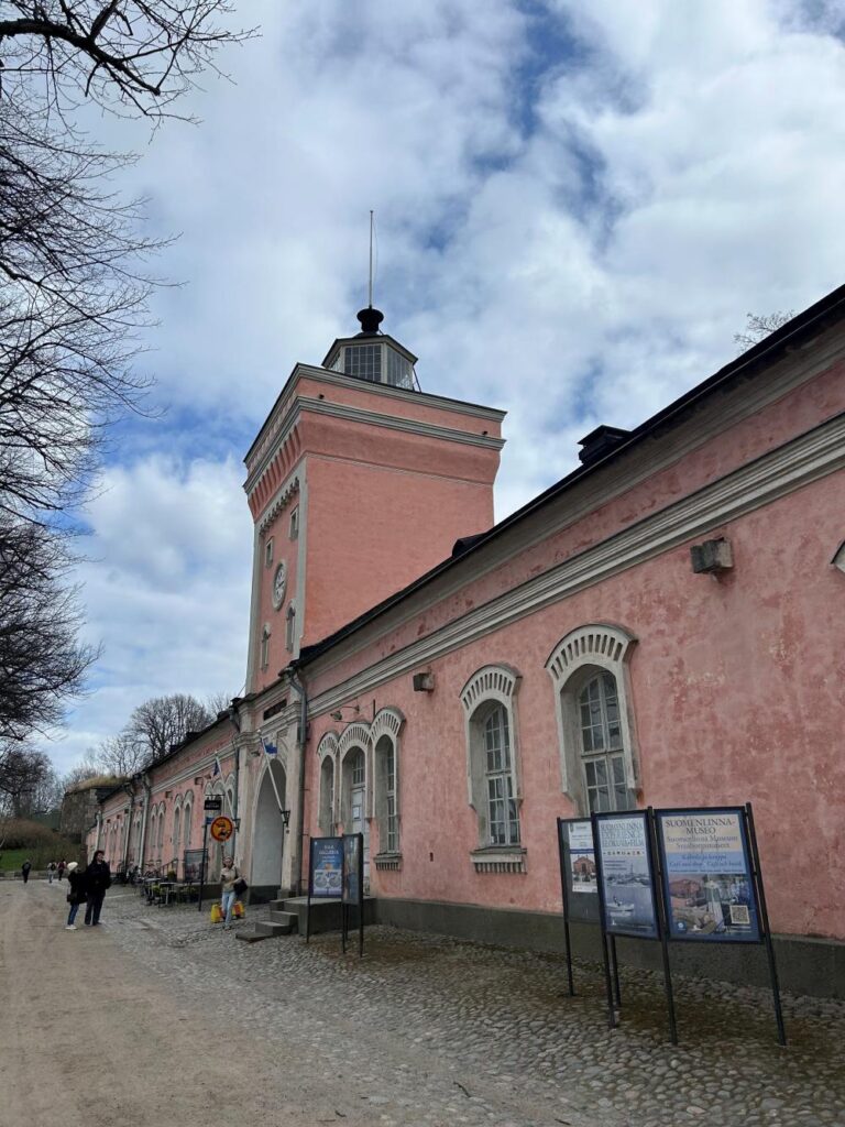 Visitors exploring centuries-old fortifications at Suomenlinna with sea views in every direction