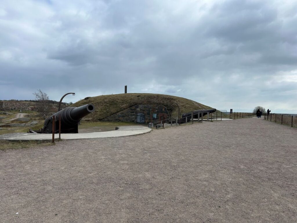 Historic cannons positioned along the walls of Suomenlinna Fortress