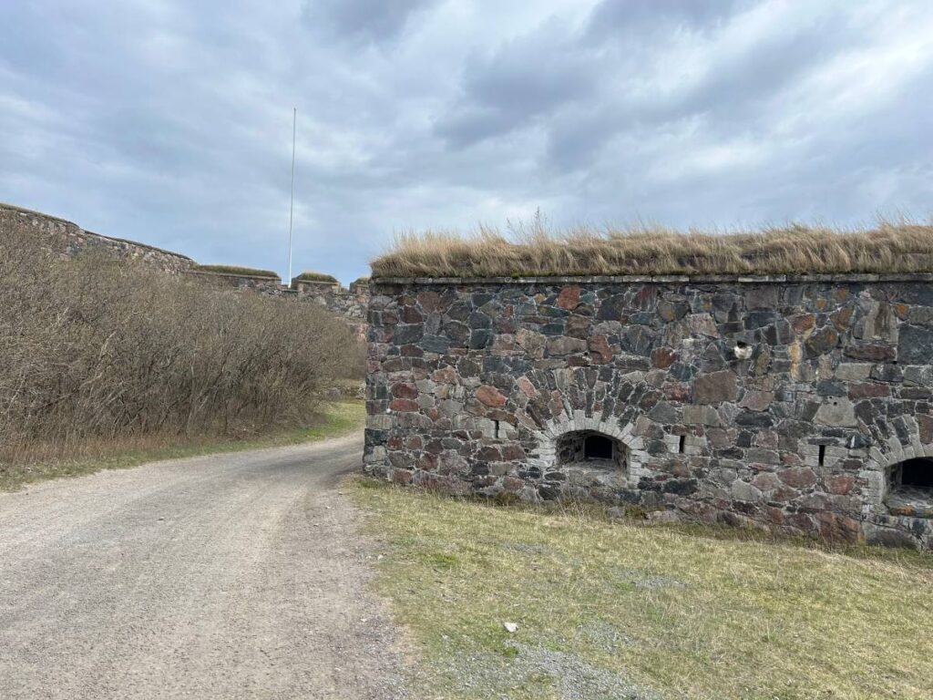 Historic stone walls winding across the landscape of Suomenlinna Fortress