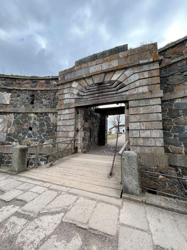 Historic fortress tunnel lined with rugged stone walls at Suomenlinna Fortress