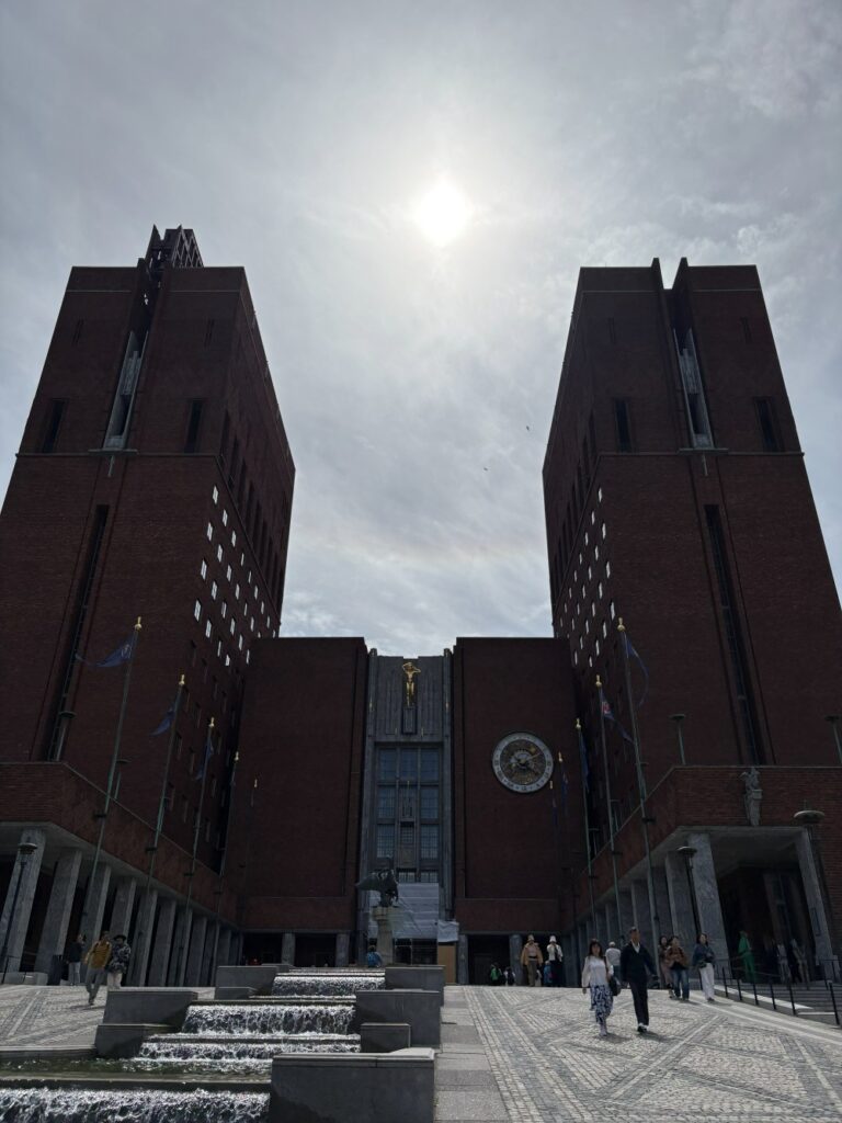 Oslo City Hall featuring distinctive red brick towers along the waterfront.