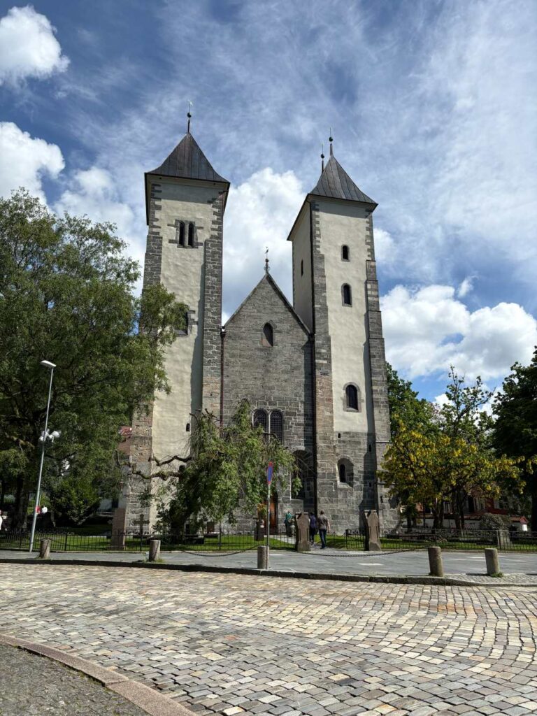 Ancient fortress buildings surrounded by green lawns at Bergenhus Fortress