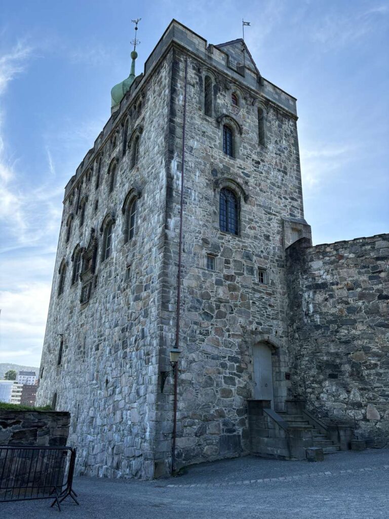 Historic stone walls of Bergenhus Fortress overlooking the harbor
