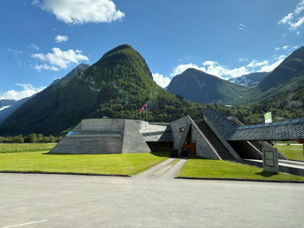Modern architecture of the Norwegian Glacier Museum surrounded by dramatic mountain scenery