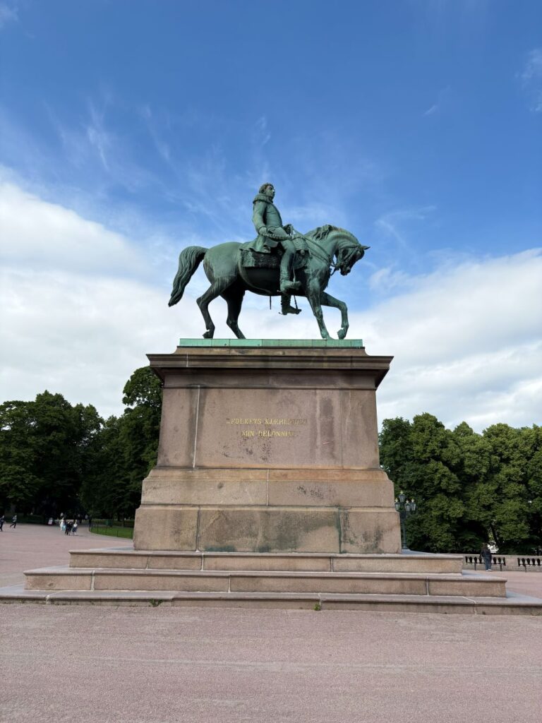 Historic Royal Palace surrounded by lush gardens in Oslo.
