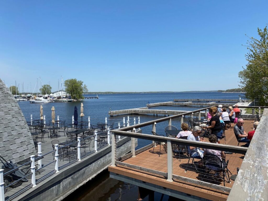 Elegant outdoor patio dining at The Barracks Inn Restaurant & Bar with sunset views over the water