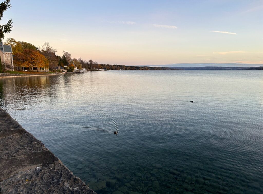 Scenic waterfront in Skaneateles surrounded by colorful fall leaves.