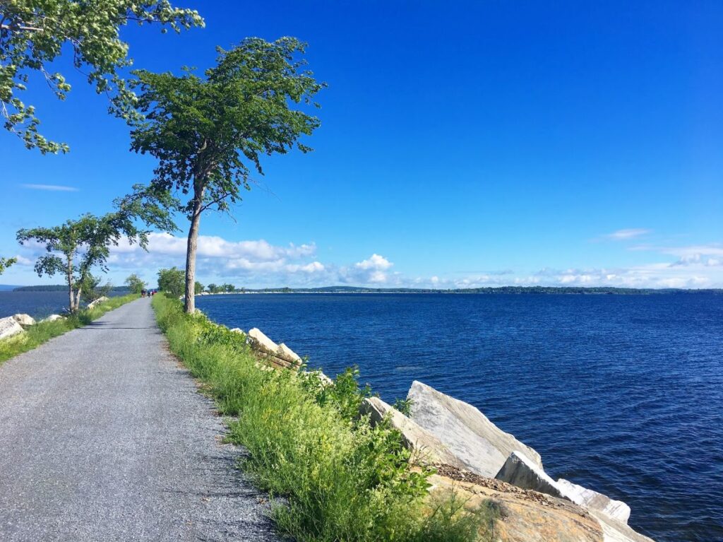 Long Colchester Causeway Trail across Lake Champlain framed by colorful autumn scenery in Vermont in Fall