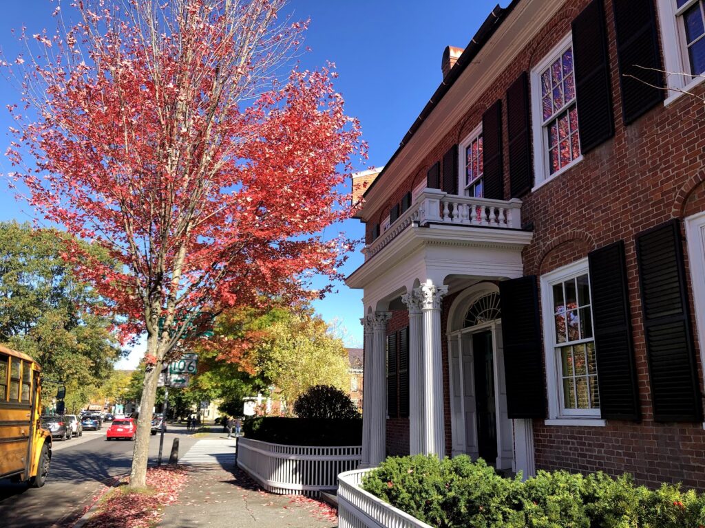 Woodstock village green surrounded by colorful trees and classic architecture during Vermont in Fall