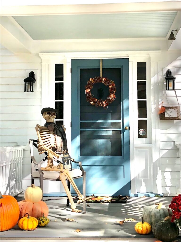 Elaborately decorated Woodstock homes with Halloween displays and colorful foliage during Vermont in Fall