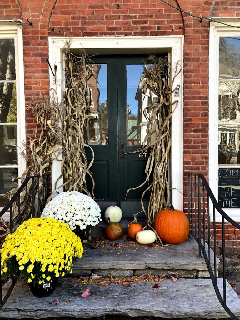 Halloween decorations and historic homes lining the streets of Woodstock during Vermont in Fall