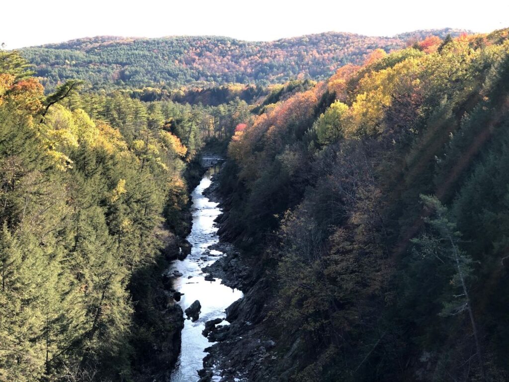 Quechee Gorge surrounded by brilliant autumn foliage during Vermont in Fall