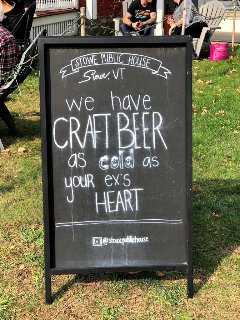 A board displayed outside a local craft beer shop in Stowe Village, Vermont.