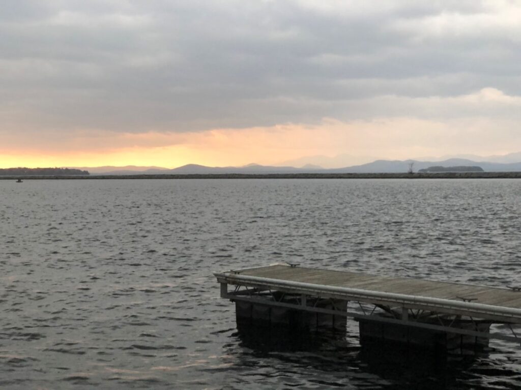 Lake Champlain waterfront in Burlington with Adirondack Mountain views during Vermont in Fall