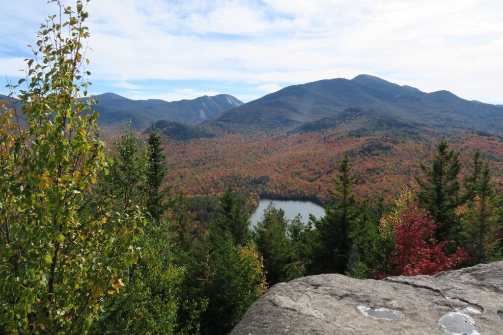 Scenic Adirondack mountain drive showcasing spectacular fall foliage near Syracuse.