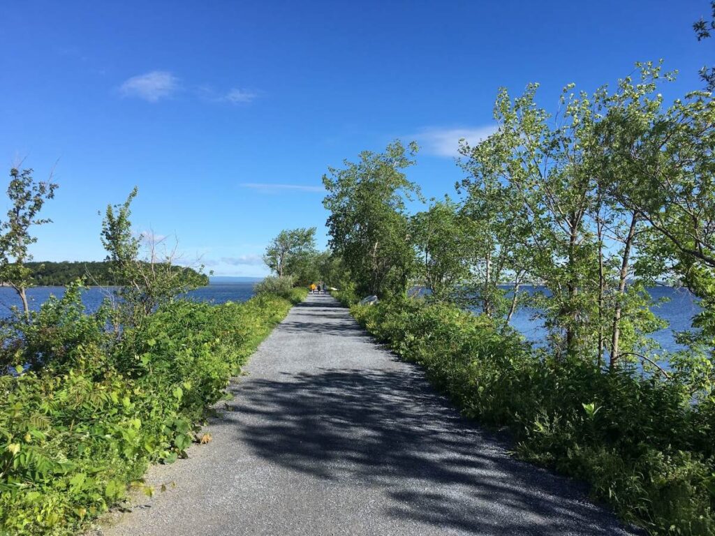 Scenic Colchester Causeway Trail surrounded by Lake Champlain and vibrant fall colors during Vermont in Fall