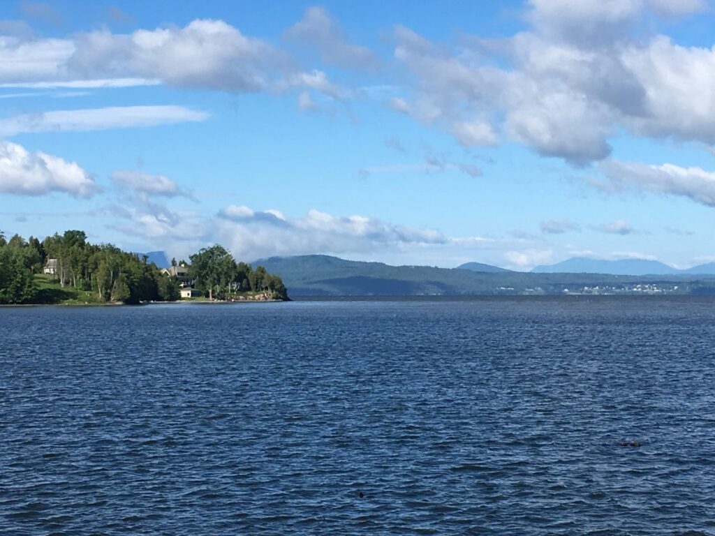 Colchester Causeway Trail stretching across Lake Champlain with colorful autumn foliage during Vermont in Fall