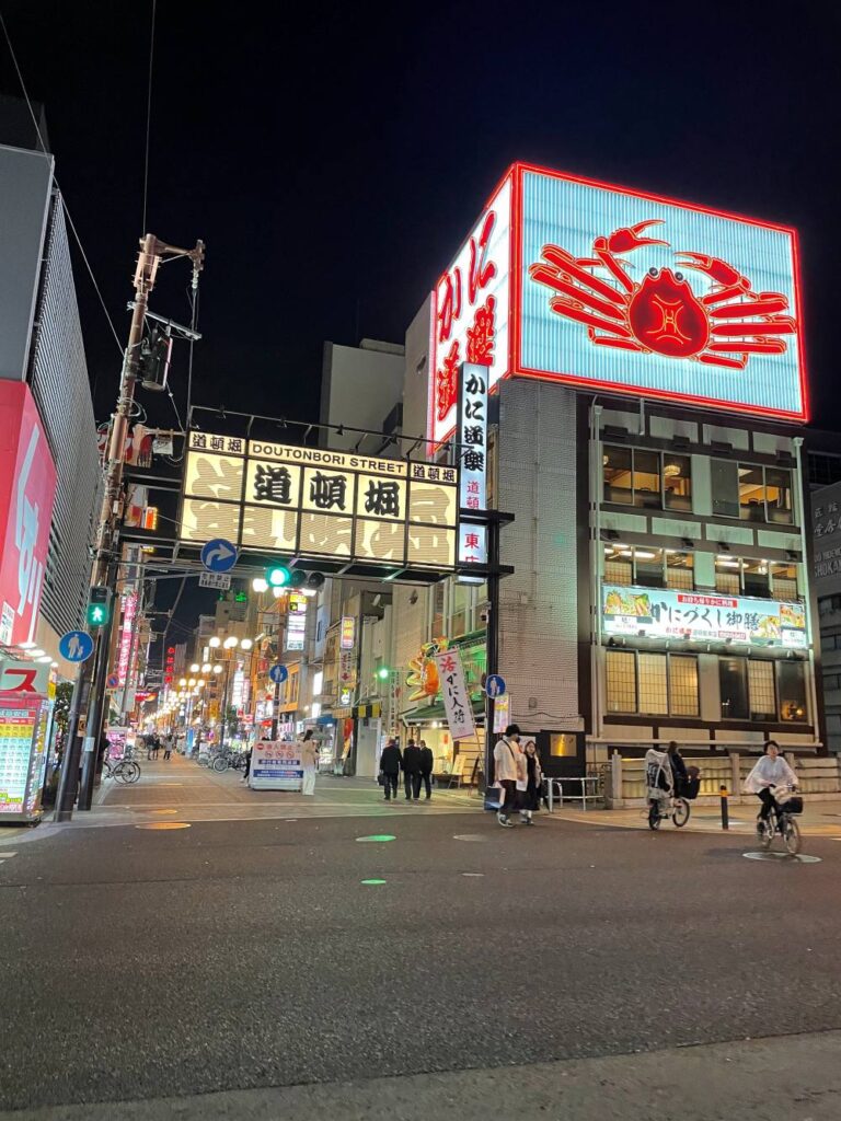 Exploring Dotonbori at night during a three-day Osaka trip, with busy streets, restaurants, and colorful neon signs