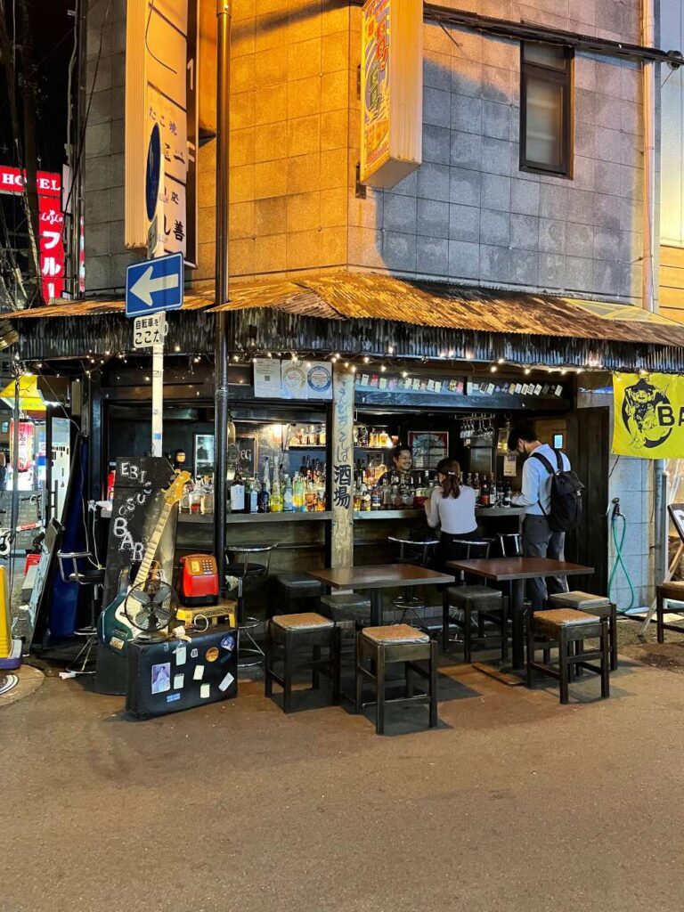 Dotonbori streets at night filled with pedestrians, restaurants, bright signs, and Osaka's lively nightlife