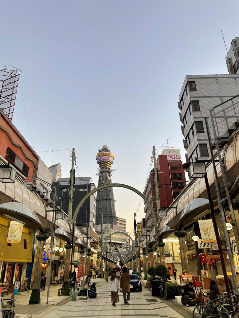 Shinsekai neighborhood in Osaka with colorful signs, traditional restaurants, and the iconic Tsutenkaku Tower