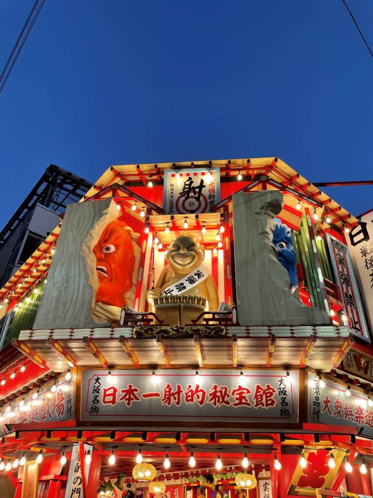 Dotonbori neon lights and colorful shop signs illuminating the streets of Osaka at night
