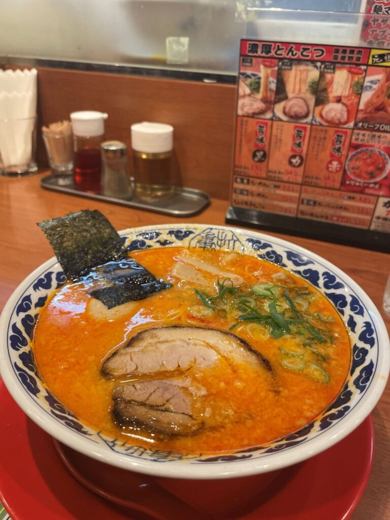 the spicy Old-fashioned Red (Mukashi Aji Aka) ramen from Kyushu Ramen Kio, featuring a rich tonkotsu pork bone broth blended with spicy miso paste and special spices