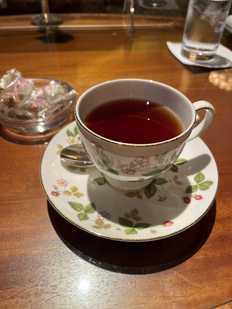 Afternoon tea set at The Ritz-Carlton Osaka showcasing an assortment of delicate desserts and savory bites in an elegant setting